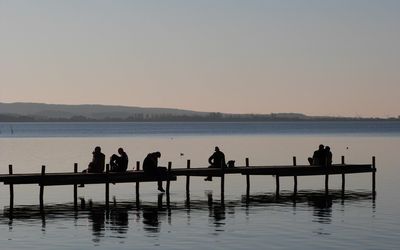Entspannen am Steinhuder Meer Mehrere Personen sitzen auf einem Steg am Steinhuder Meer und geniessen den Nachmittag