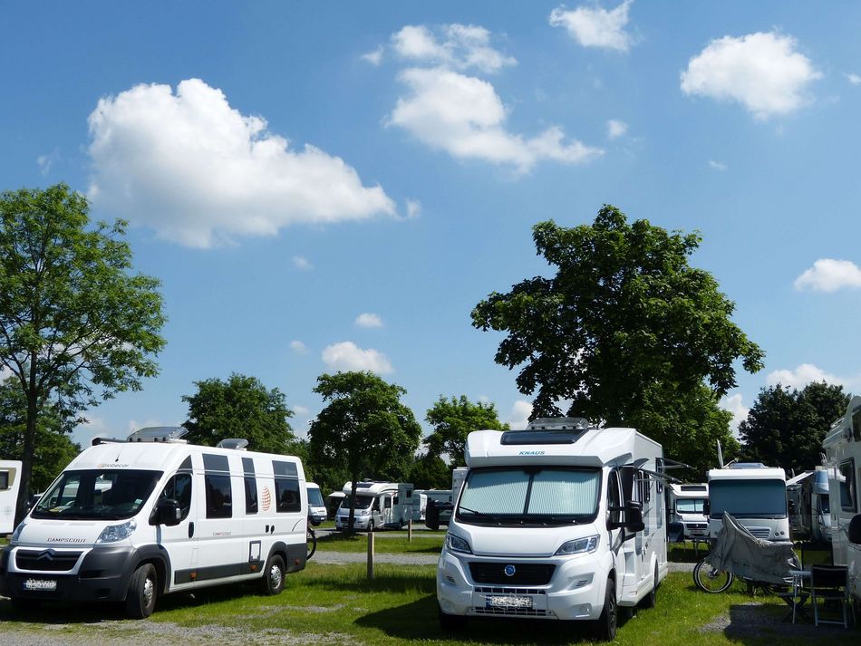 Wohnmobilstellplatz Steinhude gefüllt Mehrere Wohnmobile stehen an einem schönen Sommertag mit blauem Himmel und weißen Wölkchen auf dem Wohnmobilstellplatz Steinhude